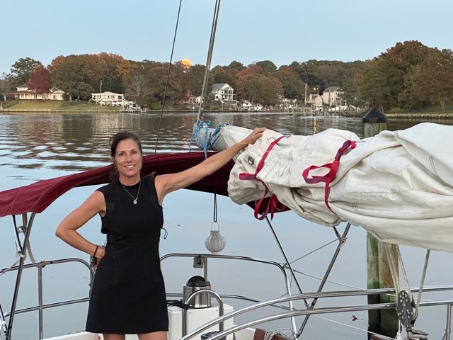 Woman standing in her sailboat's cockpit Woman standing in her sailboat's cockpit