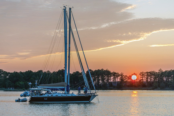 Sailboats at anchor with sunset in background Sailboats at anchor with sunset in background